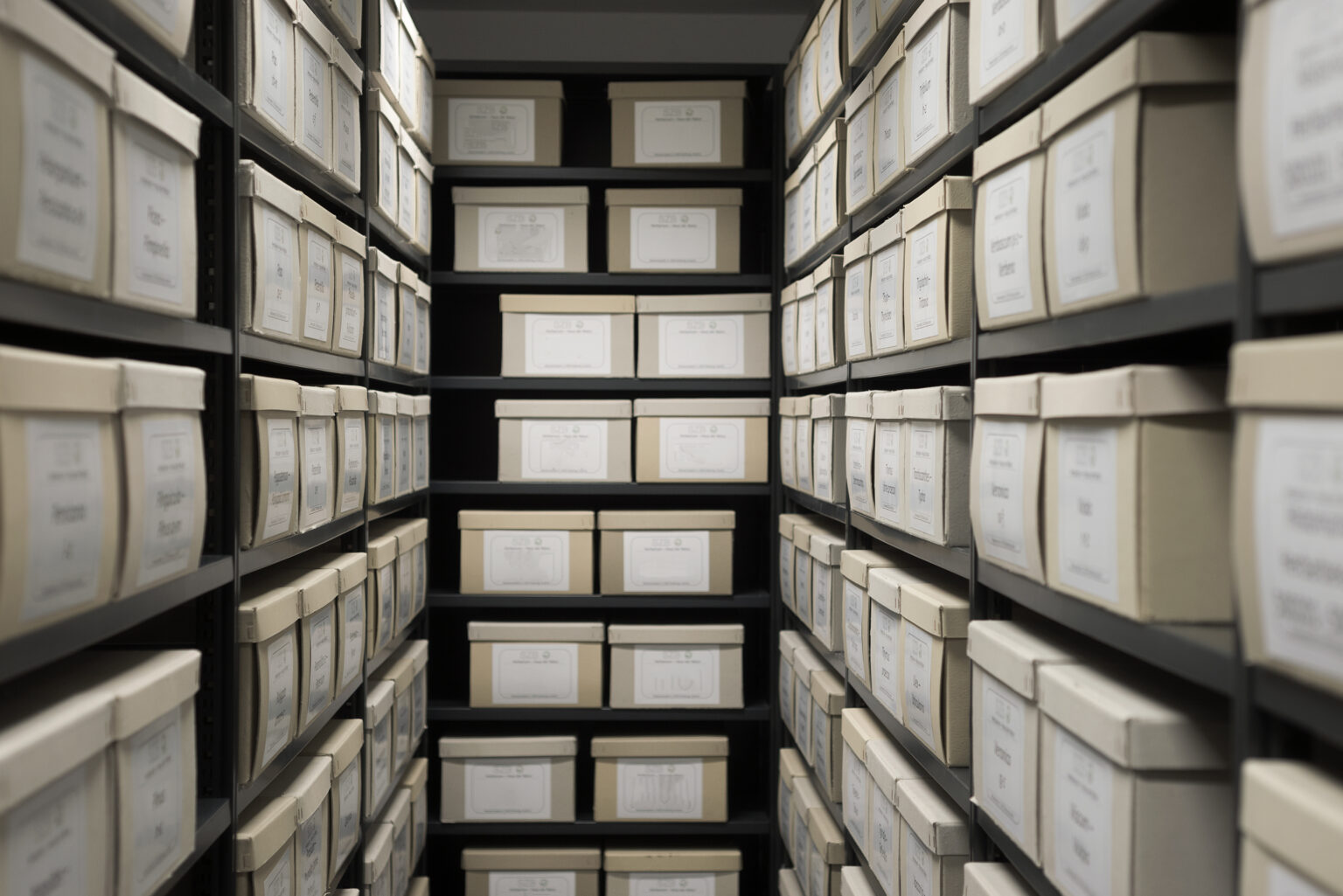 Rows of archive boxes on shelves — the weight of accumulated complexity